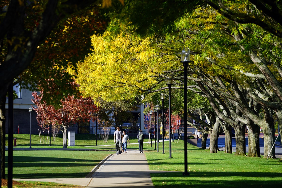 Students walk outside on East Campus among colorful trees
