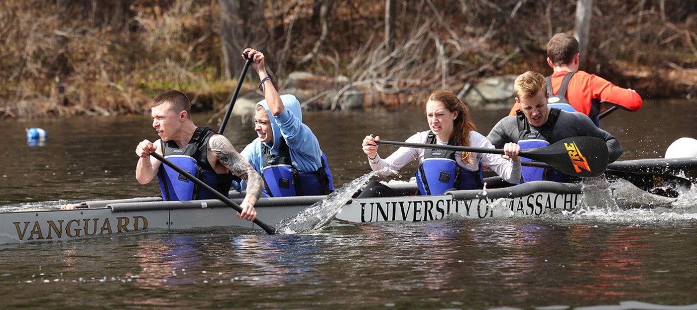 Timothy Roberts, Natalie Melconian, Rebecca Gonsalves-Lamontagne, and Zachary Morris paddle UMass Lowell's concrete canoe, named "Vanguard" during the 2014 regional competition.