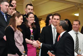 Gov. Deval Patrick shakes hands with students at the 29 Who Shine event at the State House, including UMass Lowell student Mike Mizzoni, second from right.