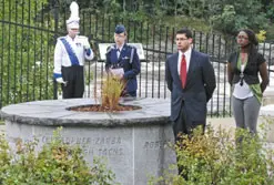Students read the history of the UMass Lowell-associated victims at the 911 Unity memorial yesterday. Reading, from right, are Eunice Delice, Brian Dano and Allana Kealy. An unidentified member of the UMass Lowell band, far left, complemented the ceremony with bell-ringing. Lowell Sun photo by Jon Hill