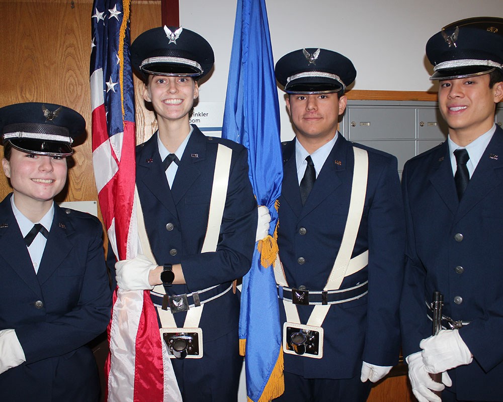 Four Air Force Reserve Officers' Training Corps Honor Guard students prepare to participate in a ceremony.