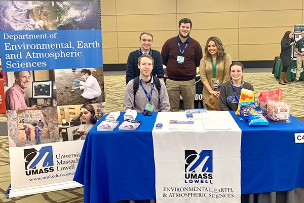 Students pose for a photo at the EEAS table during the student conference