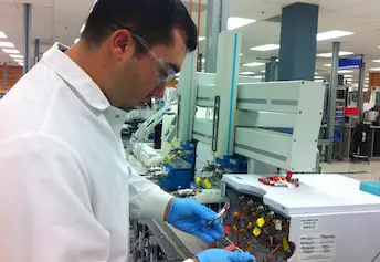 Aaron Stella prepares a liquid chromatograph mass spectrophotometer for the analysis of drug concentrations in human blood specimens.