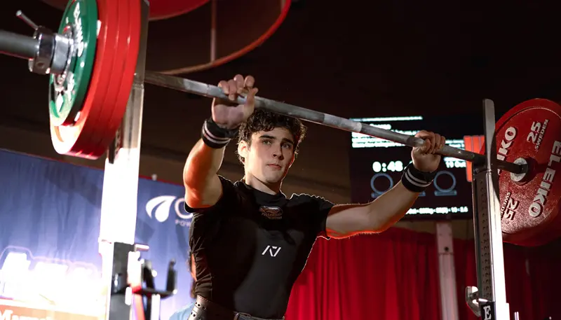 Aidan George lifting a barbell as part of the UMass Lowell Powerlifting Club.