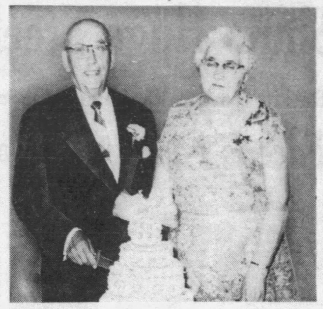 A newspaper clipping of Alberto and Dorina Givonetti, an elderly Italian couple posing behind a cake for their 50th Wedding Anniversary.