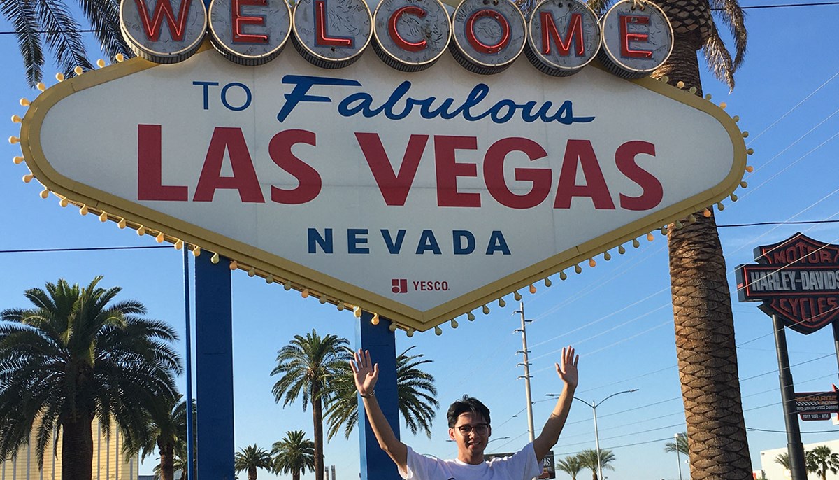 Augustin Cruz in front of the Welcome to Las Vegas sign