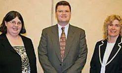 Profs. Carol Barry, left, and Joey Mead, right,&nbsp;with keynote speaker Michael McGee of Nypro Inc.