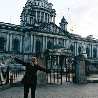 Student standing in front of Belfast City Hall in Ireland