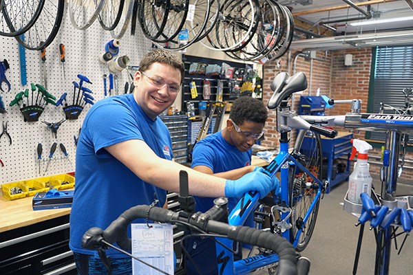 Students repair a bicycle in the new bike workshop