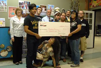 Gathered for the &ldquo;big check&rdquo; presentation are, from left, Kit Harbison, Revolving Museum (RM) development director; student Bernard Long; Joe MacFadzen, RM art technician; Prof. Robert Forrant, RM board chair; Diana Coluntino, RM artistic director; students Alex Drouin and Brittney Swindel; Stanley J. Usovicz, Verizon regional director for external affairs; student Christine Nousaath and Adam Norton, RM artist educator.