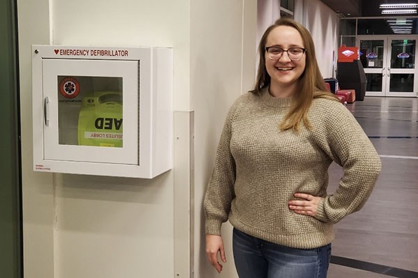 Honors biology major Katie Moreland by a defibrillator in University Suites