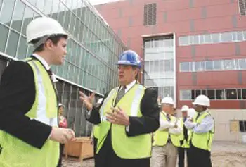 UMass President Robert Caret, center, talks with UMass Lowell student trustee Jim Tarr of Methuen, after touring the new emerging-technologies building under construction.