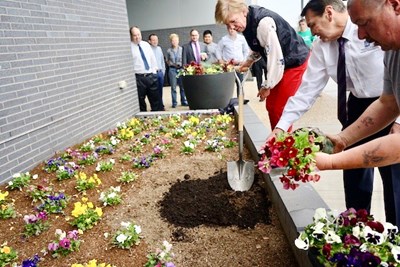 UML staff members plant flowers using compost generated from dining halls