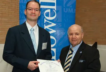 Rep. James Miceli&nbsp;, right, recognizes&nbsp;Assoc. Prof. Daniel Schmidt with the &ldquo;University Research Champion&rdquo; award for researching safer alternatives to toxic chemicals with seed funding from TURI.
