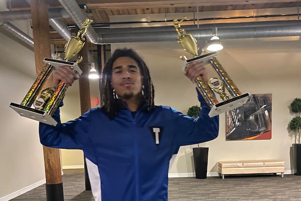 E'Armani Corporan with two trophies