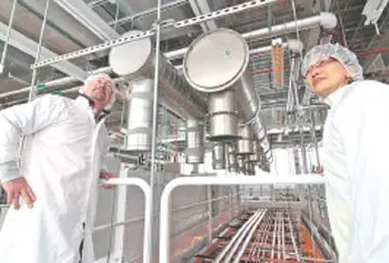 Kenneth J. Grizzell Leed, AP, project manager for the new UMass Lowell Emerging Technologies Building, shows different plumbing and duct work above the "clean room" to Julie Chen, Ph.D., vice provost for research.