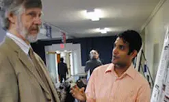 Director of TURI, Prof.&nbsp;Mike Ellenbecker of Work Environment, talks to student Sethumadhavan Ravichandran about his award-winning research on finding a greener solution to brominated-flame retardants, a toxic chemical used in foam products such as infant car seats, mattresses and pillows.