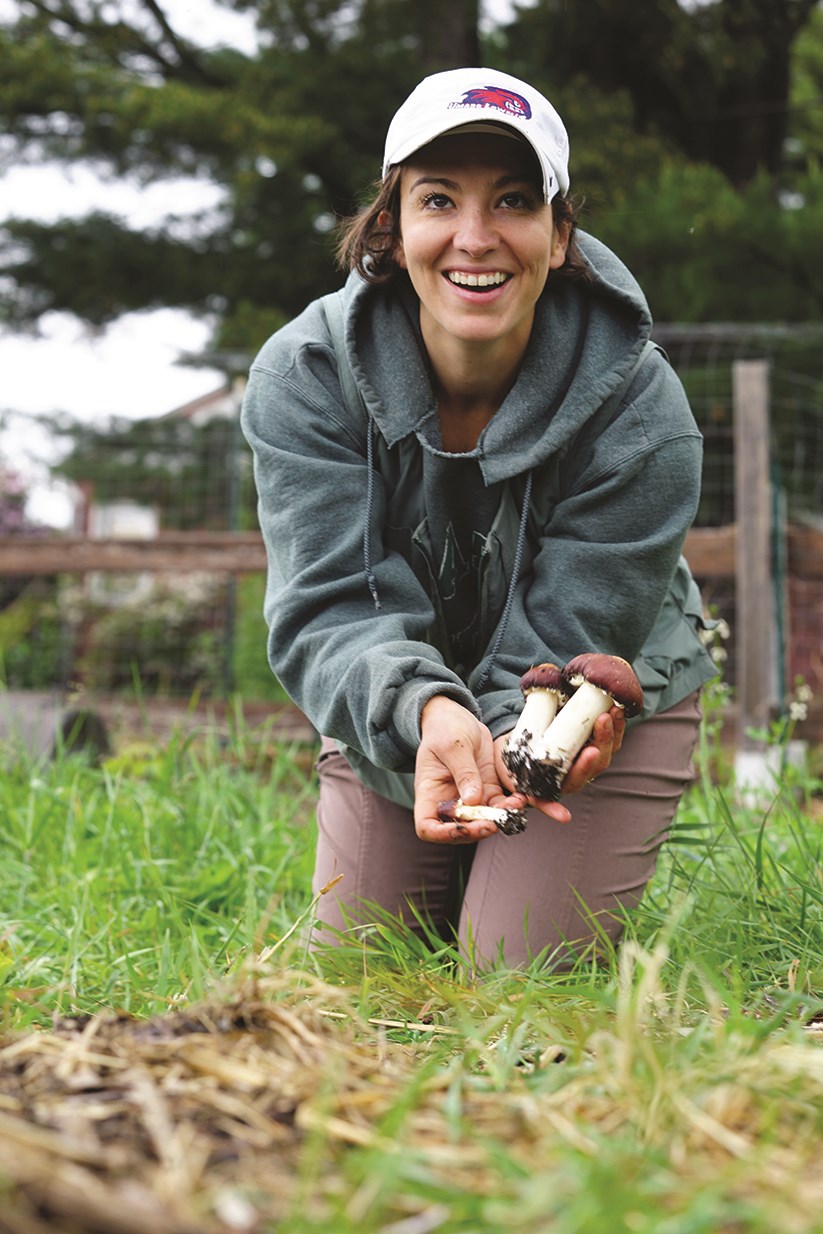 Emily Makrez harvesting mushrooms