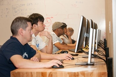 Men working on computers