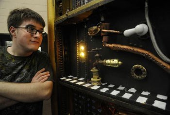 The participants in “Steampunkinetics: Building Art into Science” unveil their creation last month in Lowell./Boston Globe photo by Mark Wilson