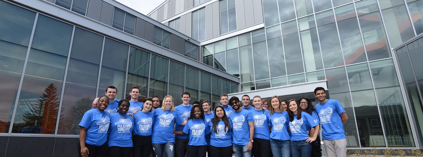 Students standing in front of the newly opening Pulichno-Tong Business Building at UMass Lowell.