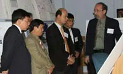 Prof. Craig Armiento, right,&nbsp;shows senior projects in the Assistive Technology Lab to delegates from the Hanoi University of Technology.