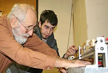 Physics instructor Herbert Fox and student Frank Gelsomini work in the physics lab.