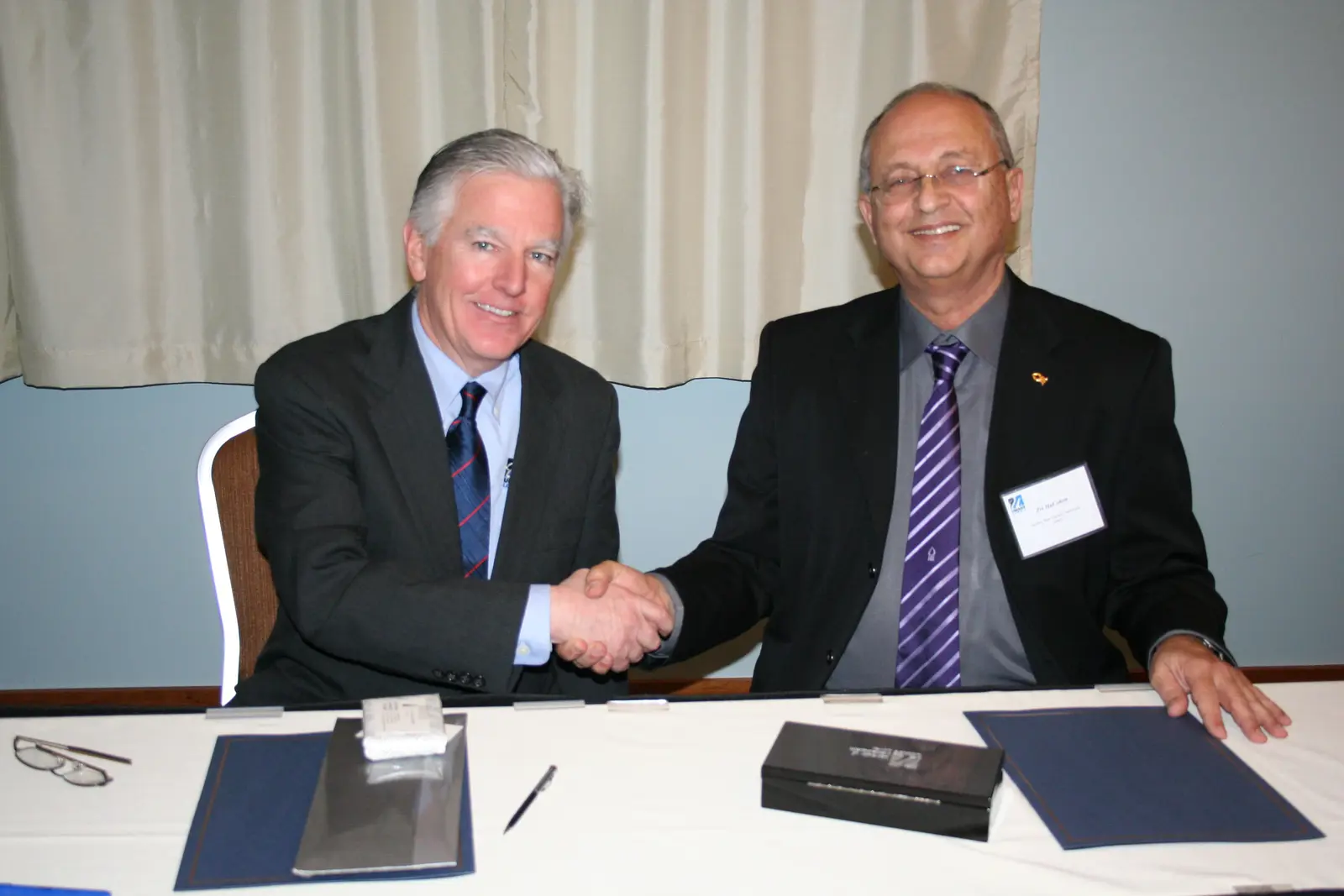 Chancellor Marty Meehan and Rector Zvi HaCohen of Israel&rsquo;s Ben-Gurion University sign an agreement that outlines areas of academic, research and experiential learning collaboration.