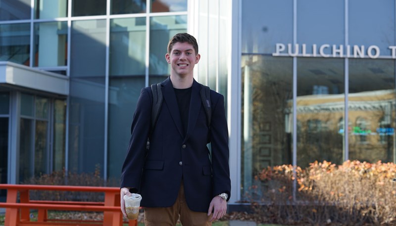 Jason McKeon poses for photo in front of Pulichino Tong building.