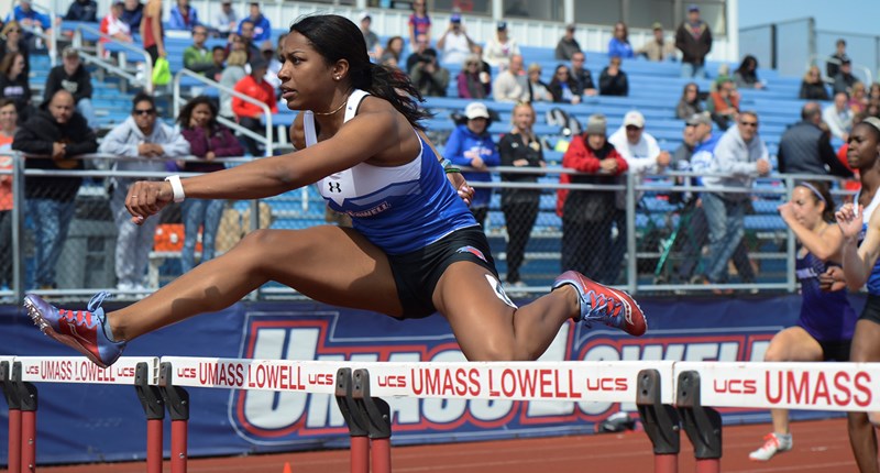 Jessica Amedee doing hurdles at a track event at UMass Lowell