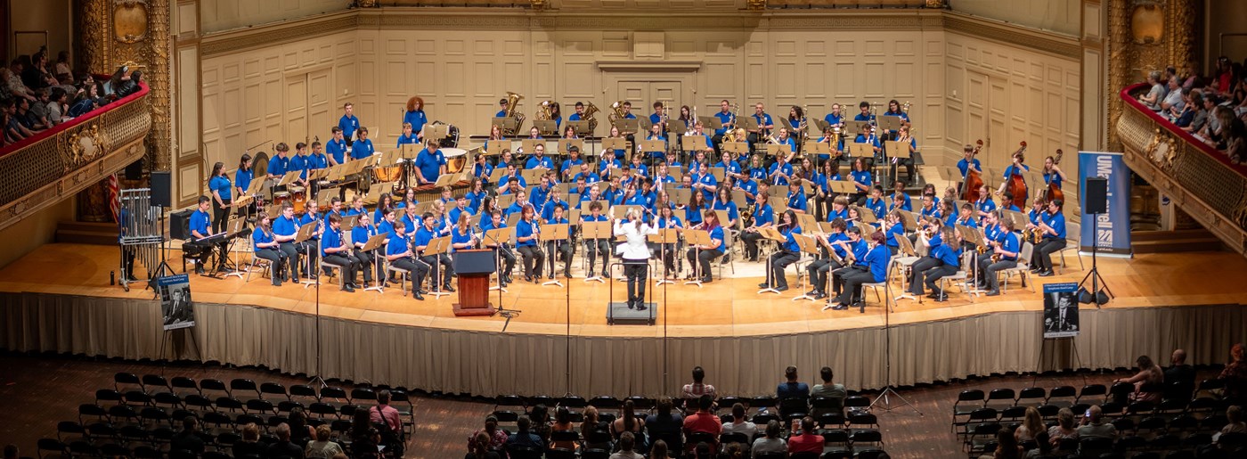 UMass Lowell's Symphonic Band camp on stage at Symphony Hall in Boston