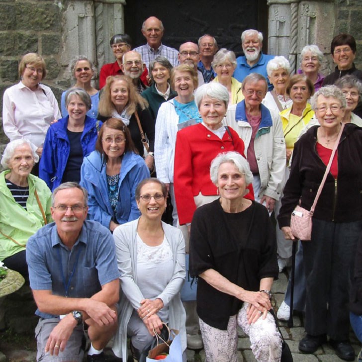 Group of old retirees on castle steps