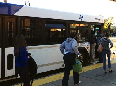 People getting on a Lowell Regional Transit Authority (LRTA) bus.