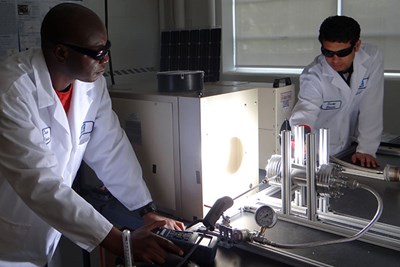Students work with the solar simulator in the lab