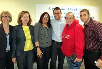 Celebrating at the Lawrence Senior Center were Robin Toof, Center for Family, Work and Community; Prof. Carol McDonough, and student trainers Yisbeel Oviedo, Alex Olson, Vanessa Kahrman and Jason Bouchrouche.
