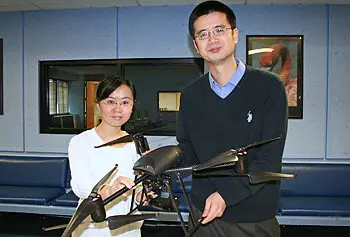 Computer Science Ph.D. student Zhongli Liu, left, and Asst. Prof. Xinwen Fu hold a prototype of the remotely operated 'HAWK' mini chopper.