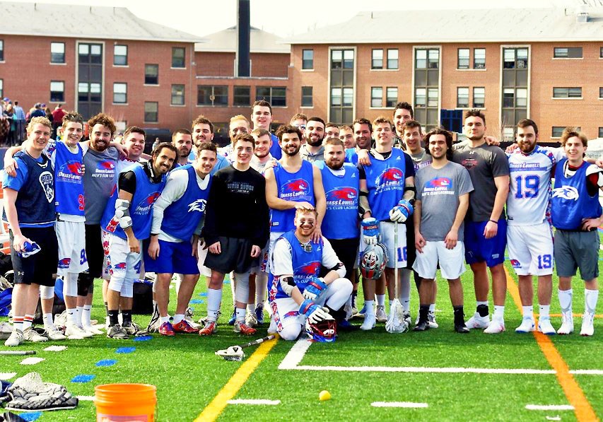 Men's club lacrosse team poses after team victory