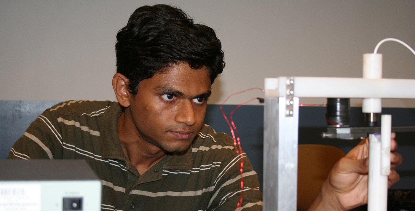 Electrical and Computer Engineering student working with unknown equipment