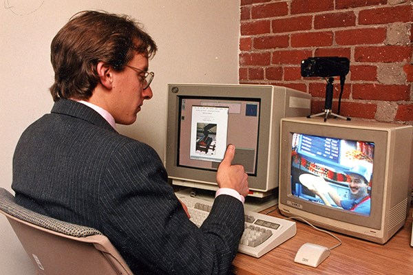 Rich Miner in the late 1980s using videoconferencing technology he developed to order pizza from a shop in downtown Lowell.
