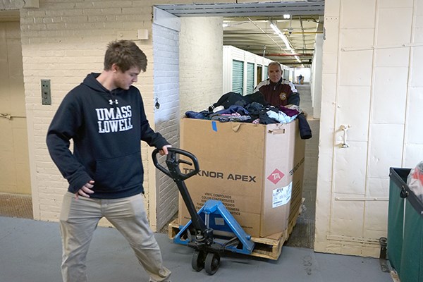 Michael Doherty pulls a pallet jack of donations at Catie's Closet
