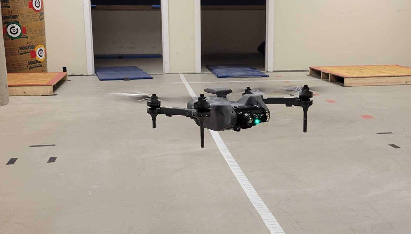A small unmanned aerial system (sUAS), the Lumenier Nighthawk V3, hovers in the NERVE Center test course.