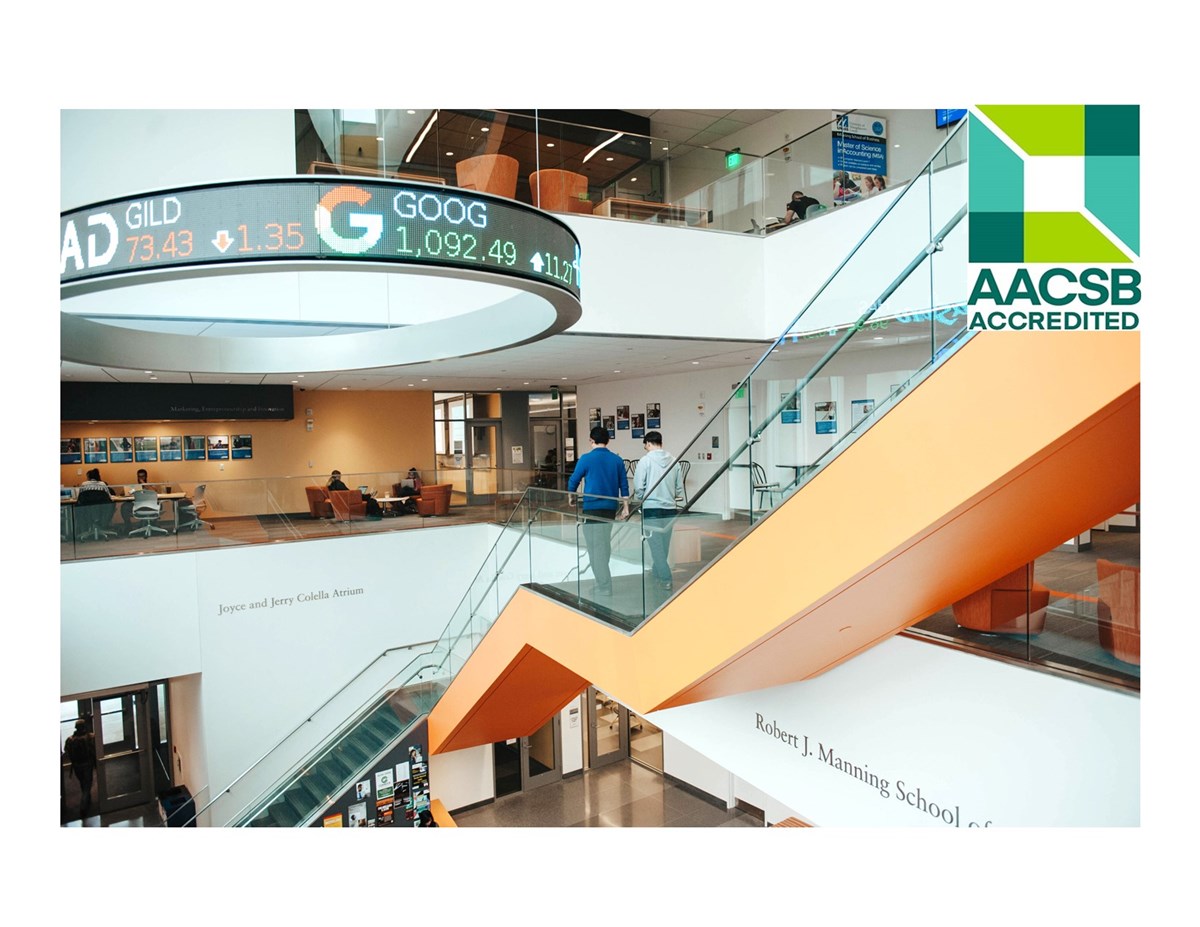 Interior lobby of the Pulichino Tong Business Center with green square logo & words: AACSB Accredited.
