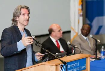 Activist John Prendergast addresses a packed auditorium as U.S. Rep. James McGovern and Gordon Halm, grad student in Peace and Conflict Studies, listen.