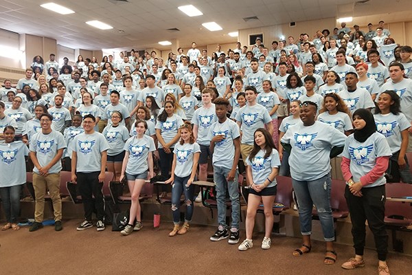 Members of the River Hawk Scholars Academy wearing t-shirts for their induction ceremony.