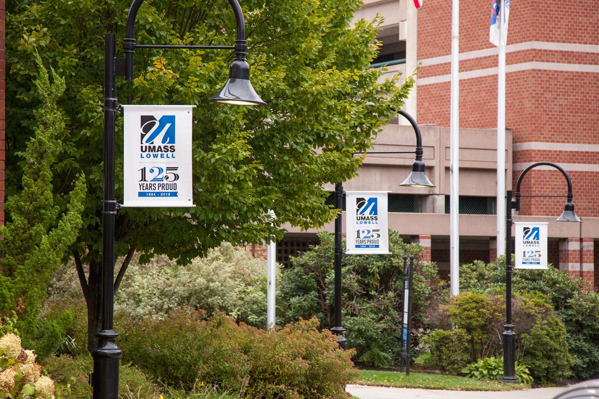 Lightposts with UMass Lowell 125 anniversary banners in front of Inn & Conference Center