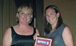 NE-10 Conference Commissioner Julie Rupert congratulates UMass Lowell SAAC Chair-Elect Amy Delgado.
