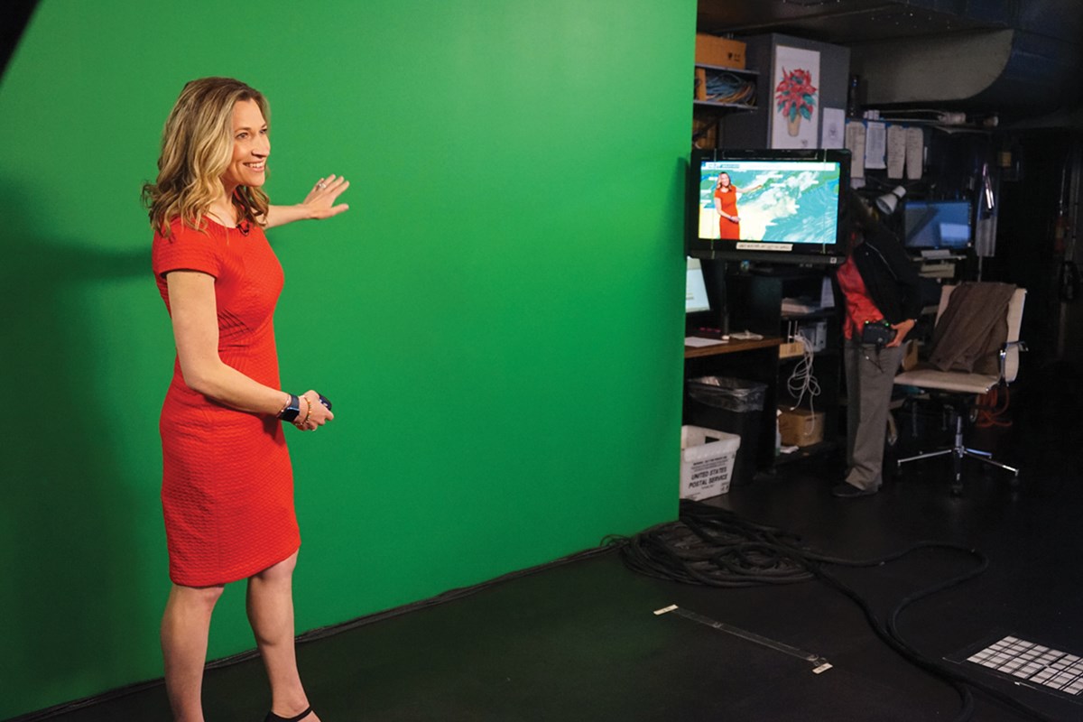 Meteorologist Sarah Wroblewski in front of a green screen