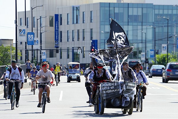 A pirate-themed bicycle-powered vehicle crosses a bridge 
