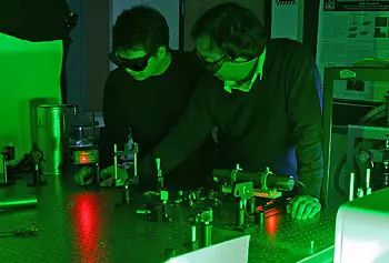 Assoc. Prof. Mengyan Shen, right, works with postdoctoral researcher Cong Wang in the laser lab.