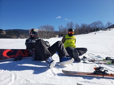 Ski and Snowboard Club Students sitting on ski mountain